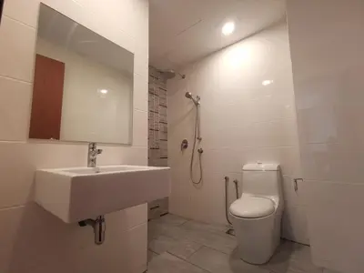 a bathroom with a sink and a toilet and a mirror at Sunrise Gurney in George Town