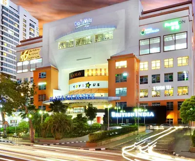 a building in a city at night with street lights at Sunrise Gurney in George Town