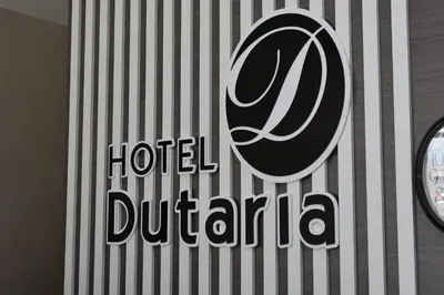 a hotel duranta sign on a wall with a clock at Hotel Dutaria in Ipoh