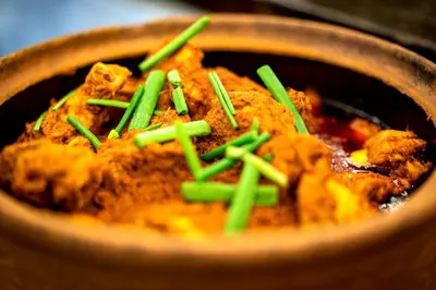 a bowl of food with green chopsticks on it at Century Pines Resort Cameron Highlands in Cameron Highlands