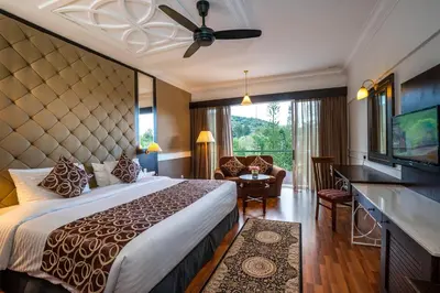 a hotel room with a large bed and a television at Century Pines Resort Cameron Highlands in Cameron Highlands