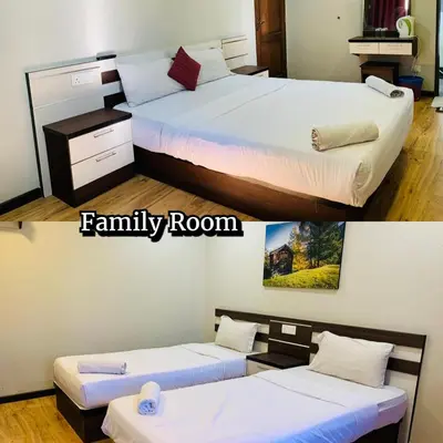 a room with two beds and a family room at Zermatt Hotel in Cameron Highlands