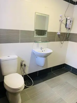 a bathroom with a toilet and a sink at Zermatt Hotel in Cameron Highlands