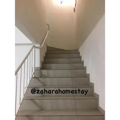 a stairway with white stairs in a building at Zahara Homestay in Cameron Highlands