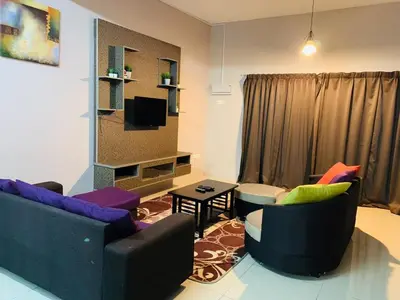 a living room with two couches and a tv at Zahara Homestay in Cameron Highlands