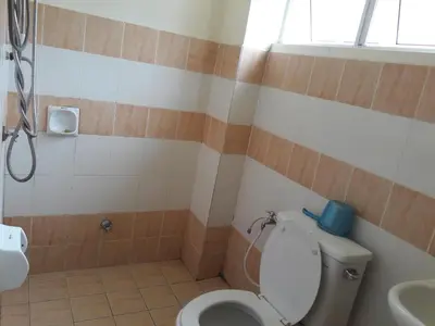 a bathroom with a toilet and a sink at Jeffrey Homestay B @ Lost World of Tambun in Ipoh