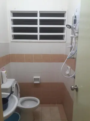 a bathroom with a toilet and a shower with a window at Jeffrey Homestay B @ Lost World of Tambun in Ipoh