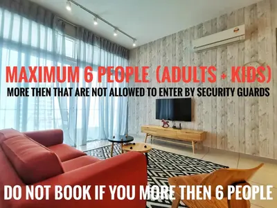 a living room with a red couch and a tv at Southbay Plaza Condominium in Bayan Lepas