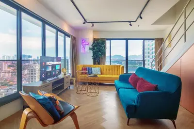 a living room with a blue couch and a tv at Sunrise Gurney in George Town