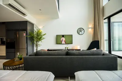 a living room with a couch and a kitchen at Sunrise Gurney in George Town