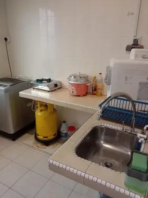 a kitchen with a sink and a counter top at ARUWDA Homestay in Ipoh