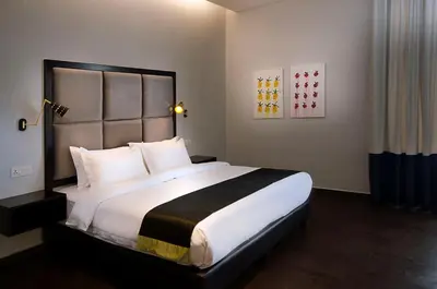 a bedroom with a large bed with white pillows at Palm Hotel Ipoh in Ipoh
