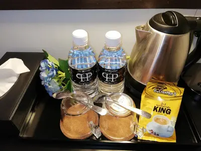 a tray with bottles of water and a pitcher at Palm Hotel Ipoh in Ipoh