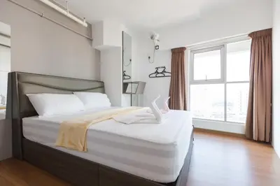 a bedroom with a large bed with a large window at 3-Bed Executive Suite, RumahKu @CEO in Bayan Lepas
