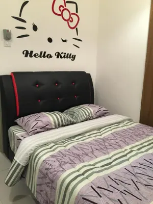 a bedroom with a bed with a hello kitty sticker on the wall at Cameron DreamWorld Apartment @ Golden Hill in Cameron Highlands