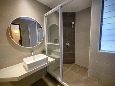 a bathroom with a sink and a mirror at GurneyVille in George Town