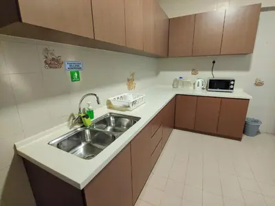 a small kitchen with a sink and a microwave at GurneyVille in George Town