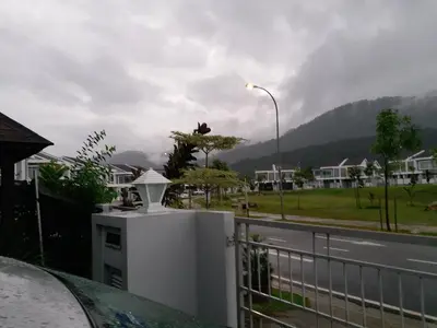 a view of a street from a balcony with a fence at VVIP Homestay Villa Proton City in Tanjung Malim