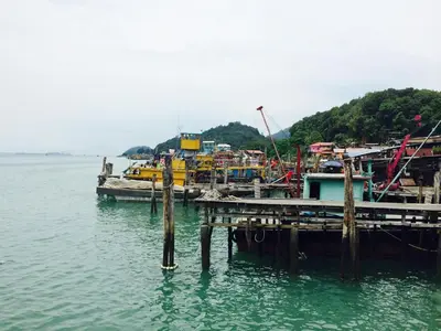 a group of boats docked at a dock in the water at Pangkor Holiday Home in Pangkor