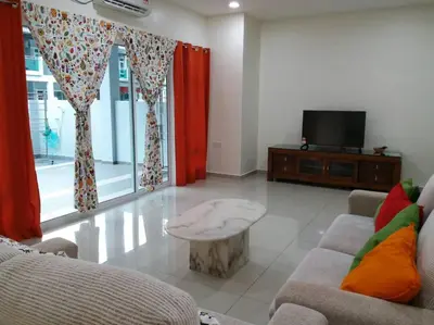 a living room with a couch and a coffee table at Pangkor Holiday Home in Pangkor