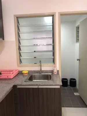 a kitchen counter with a sink and a window at Muslim Homestay Apartment in George Town