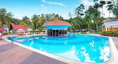 a large swimming pool with a building in the middle at The Bayview Beach Resort in Batu Ferringhi