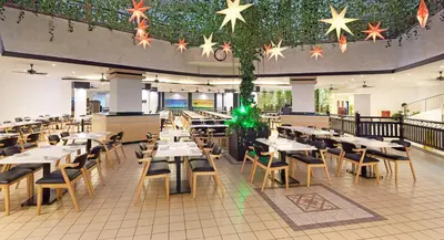 a restaurant with tables and chairs and stars on the ceiling at The Bayview Beach Resort in Batu Ferringhi
