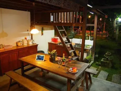 a room with a wooden table and a ladder at Nature Fruit Farm - Private Estate in Balik Pulau