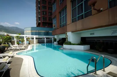 a large swimming pool on the side of a building at Berjaya Penang Hotel in George Town