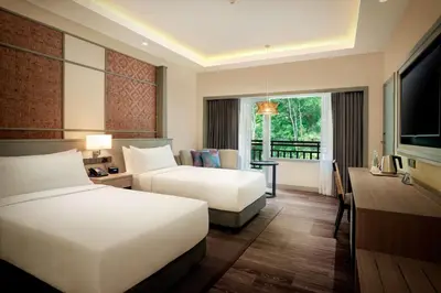 a hotel room with two beds and a television at DoubleTree by Hilton Damai Laut in Lumut