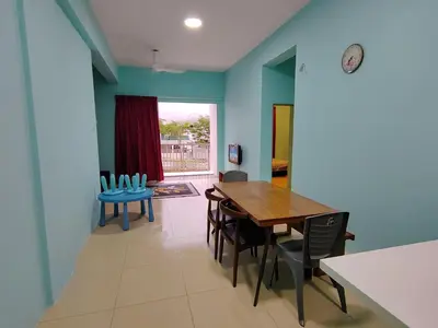 a dining room with blue walls and a table and chairs at NAZMI & LINDA CAMERON HOMESTAY in Cameron Highlands