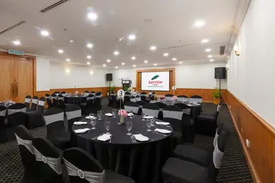a conference room with tables and chairs and a screen at Bayview Hotel Georgetown Penang in George Town