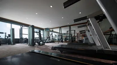 a gym with treadmills and equipment in a building at Gurney Bay Hotel, A PARKROYAL Partner Hotel in George Town