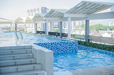 a swimming pool on top of a building at Octagon Premium Ipoh Town Center by Grab A Stay in Ipoh