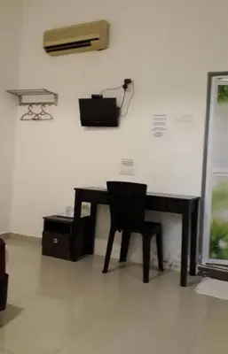 a desk with a chair in front of a wall at Max Ferringhi Hotel in Batu Ferringhi