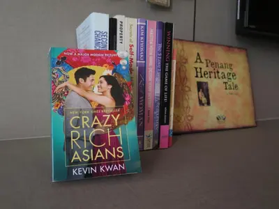 a row of books sitting on a shelf at The Landmark in George Town