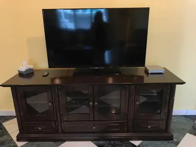 a television on top of a wooden entertainment center at Golden Hill in Cameron Highlands