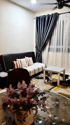 a living room with a couch and a table at Leezahomestay in Bayan Lepas