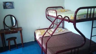 a bedroom with two bunk beds and a mirror at Pinang Beach Apartment @ Bayu Emas in Batu Ferringhi