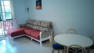 a living room with a couch and a table at Pinang Beach Apartment @ Bayu Emas in Batu Ferringhi