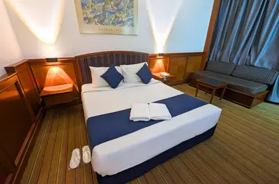 a bedroom with a large bed with two towels on it at Park Avenue Hotel Sungai Petani in Sungai Petani