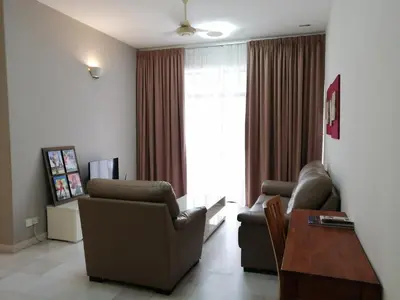 a living room with two chairs and a table at City Tropical Home I in George Town