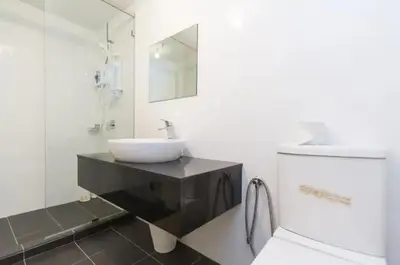 a bathroom with a sink and a mirror at Maritime Suite Holiday Rental II in George Town