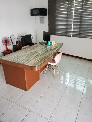 a desk in a room with a chair and a table at Little Kampung Studio in Teluk Intan