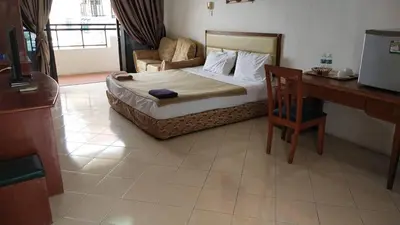 a hotel room with a bed and a desk and a desk at Marina Cove Resort in Lumut