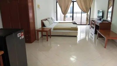a bedroom with a bed and a tv in a room at Marina Cove Resort in Lumut