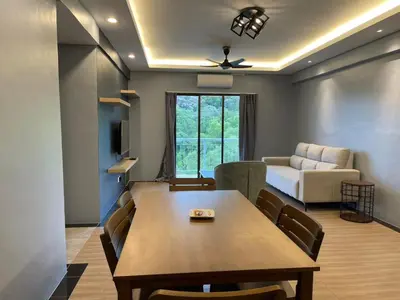 a living room with a table and a couch at Lumut Valley Condominium in Lumut