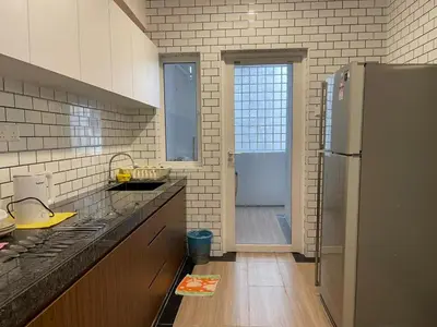 a kitchen with a refrigerator and a walk in shower at Lumut Valley Condominium in Lumut