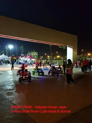 a group of children playing on toy motorcycles at a fair at Cute Hotel & Dorms Ipoh in Ipoh