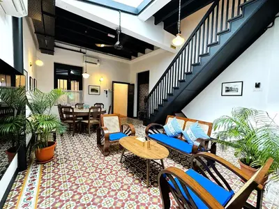 a living room with furniture and a staircase at Yeng Keng Hotel in George Town
